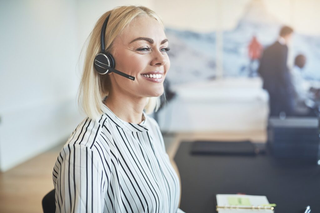 Young businesswoman smiling while talking on a headset
